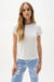 Woman wearing a fitted silky knit crew neck T-shirt styled with casual chic summer outfits, perfect for travel, resort wear, layering, or everyday modern dressing.