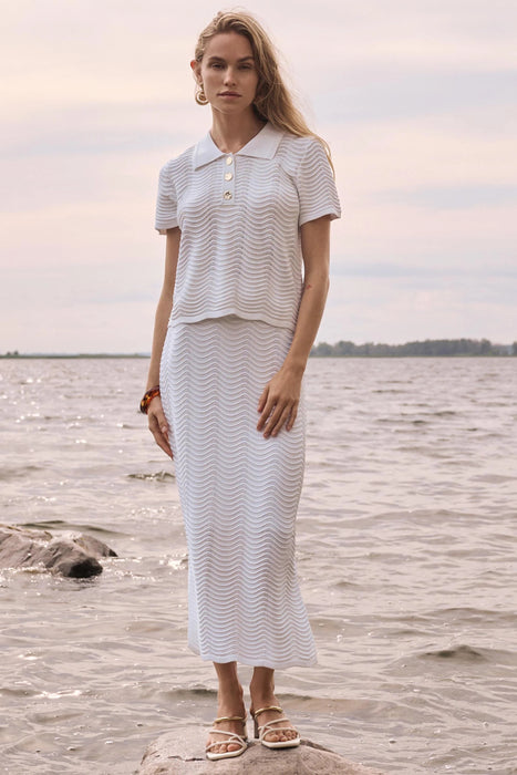 Woman wearing Joseph Ribkoff vanilla textured sweater knit pencil skirt, featuring a fitted silhouette, stretch fabric, midi length, and a sleek, elegant design.