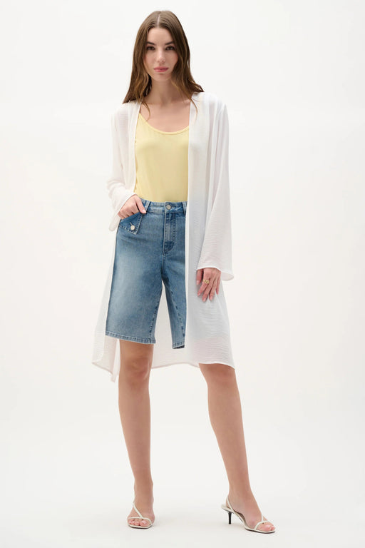 Woman wearing a lightweight gauze open-front cover-up with flare sleeves and side slits, styled for summer layering, travel, resort wear, or casual chic occasions.