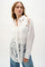 Woman wearing Joseph Ribkoff white lace embroidered blouse for elegant office outfit