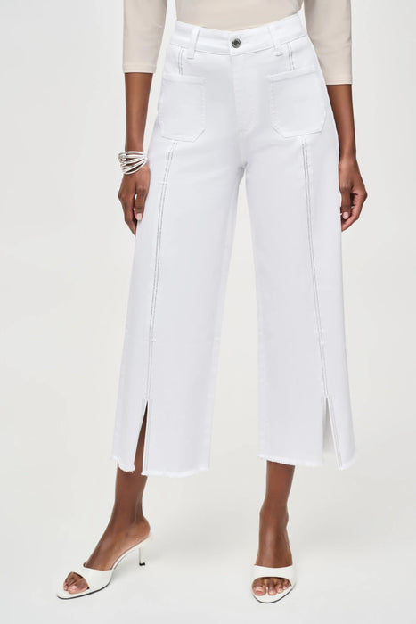 Woman wearing white cropped jeans with rhinestone embellishments and frayed hem from Joseph Ribkoff