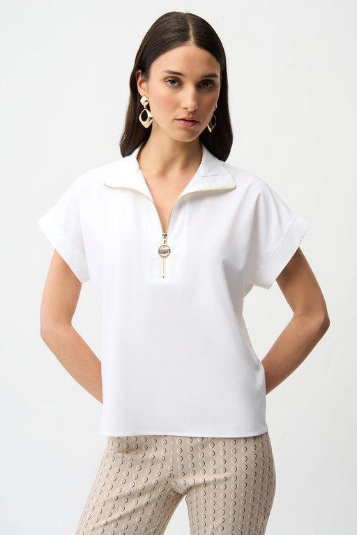 Woman wearing Joseph Ribkoff white straight boxy top with zipped V-neck styled for office casual, smart brunch, travel, and modern everyday chic outfits.