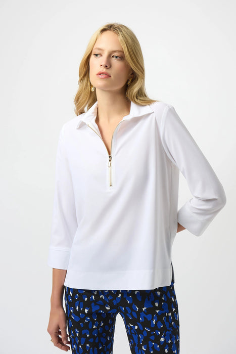 Woman wearing a white poplin top with zip front and 3/4 sleeves