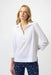 Woman wearing a white poplin top with zip front and 3/4 sleeves