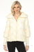 Woman wearing a white quilted puffer jacket with pearl accents and zip up front from Joseph Ribkoff