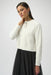 Woman wearing a white feather yarn knit cardigan with rhinestone bow detail from Joseph Ribkoff