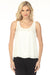 Woman wearing a white sleeveless top with scoop neckline from Joseph Ribkoff