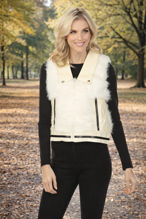 Woman wearing a white fur zip up vest with faux leather trim and front pockets from Metric Knits