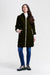 A woman modeling a black quilted hooded puffer coat with a silver zipper closure and zip pockets from Nikki Jones