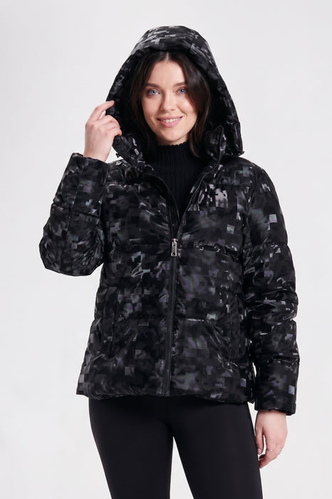 A woman wearing a black hooded puffer jacket with a digital camouflage pattern from Nikki Jones