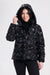 A woman wearing a black hooded puffer jacket with a digital camouflage pattern from Nikki Jones