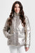 A woman wearing a shiny metallic gold puffer jacket with a high collar and front flap pockets from Nikki Jones