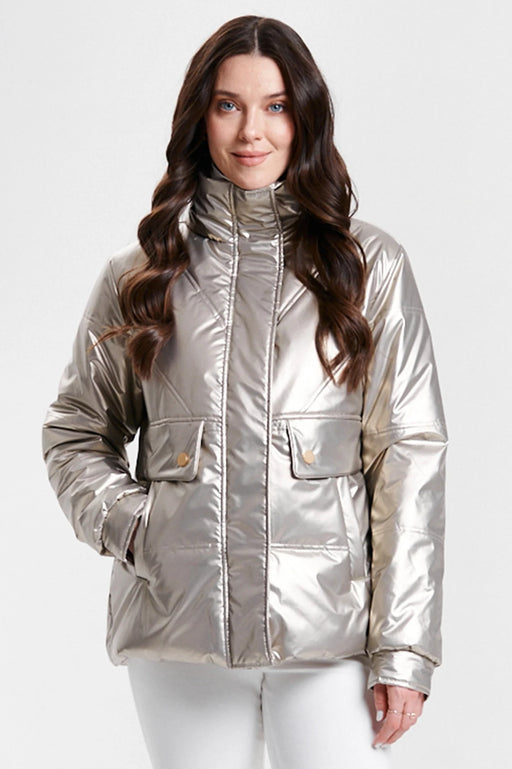 A woman wearing a shiny metallic gold puffer jacket with a high collar and front flap pockets from Nikki Jones