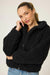 Woman wearing a black fuzzy hooded zip up jacket with long sleeves from PJ Salvage
