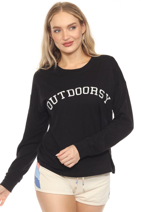 Woman wearing a black top with 'OUTDOORSY' text embroidery with crew neck and long sleeves