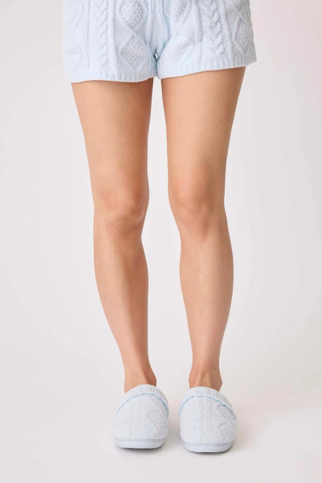 Woman wearing a light blue chenille cable knit slippers