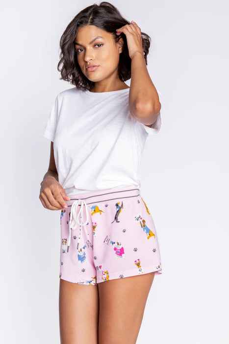 Woman wearing a pink pajama short with cute dog prints from PJ Salvage