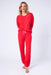 Woman wearing a red matching long sleeve top and jogger pant with star embroidery from PJ Salvage