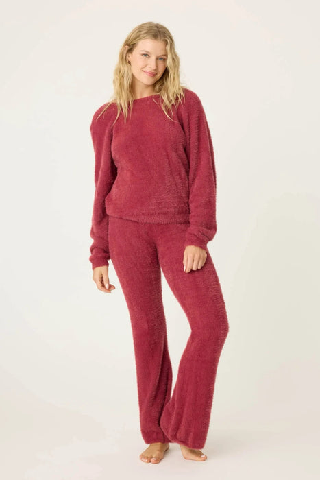 Woman wearing a red feather knit lounge set with matching top and pant
