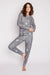 Woman wearing a gray thermal festive pajama set with snowcapped trees, skiing, and winter print from PJ Salvage