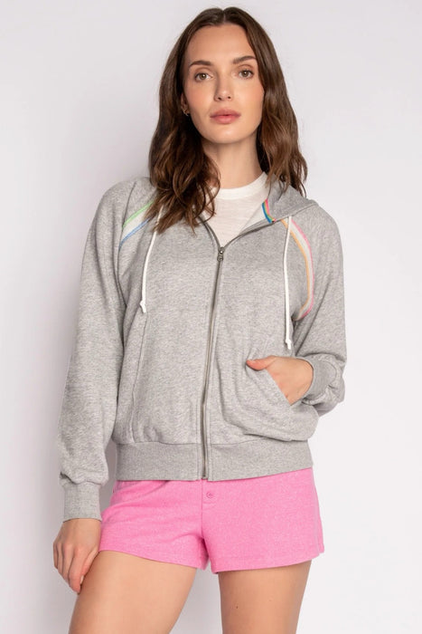 Woman wearing a gray zip-up hooded track jacket with neon stripe stitch detail