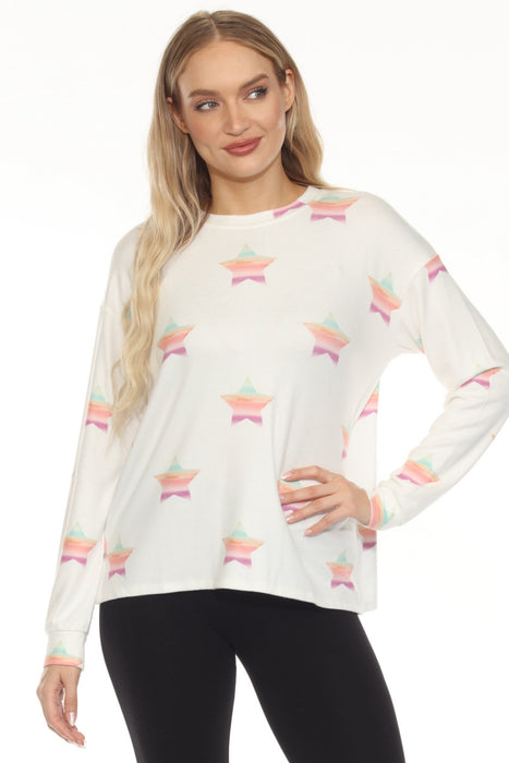 Woman wearing a white long sleeve lounge top with colorful stars pattern