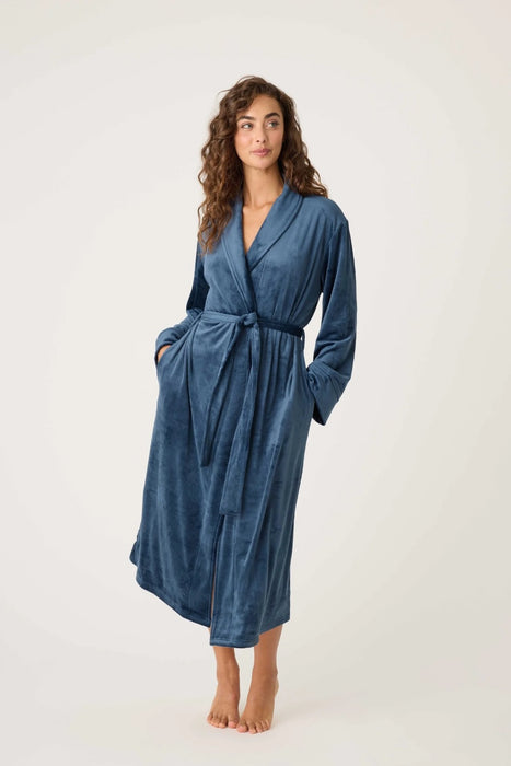 Woman wearing a navy plush velour robe from PJ Salvage