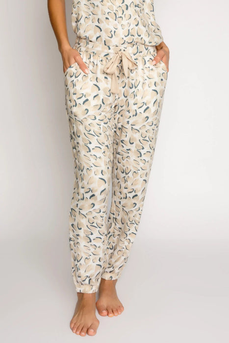 Woman wearing a leopard print jogger lounge pant with ribbon tie elastic waistband and side pockets