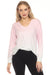 Woman wearing a light pink dip-dye gradient sweater lounge top with v-neck and studded long sleeves
