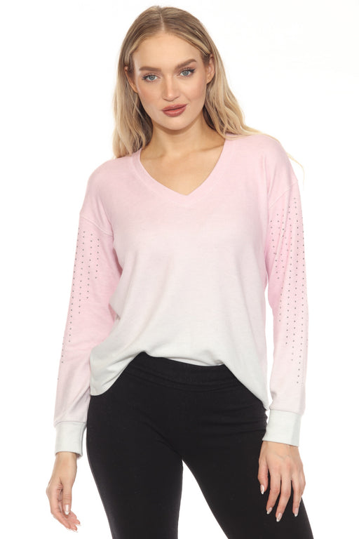 Woman wearing a light pink dip-dye gradient sweater lounge top with v-neck and studded long sleeves