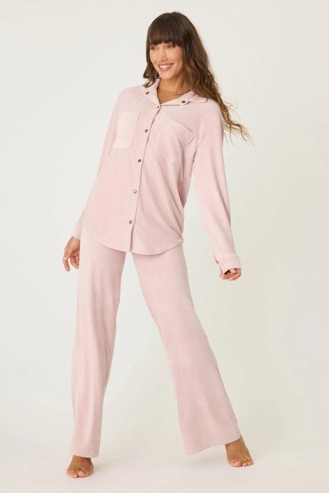 Woman wearing a matching pink corduroy pajama set with matching top and pant from PJ Salvage