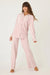 Woman wearing a matching pink corduroy pajama set with matching top and pant from PJ Salvage