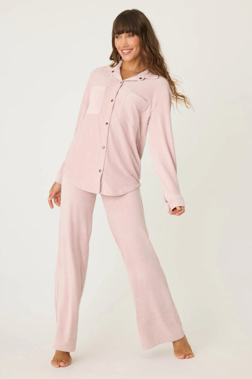 Woman wearing a matching pink corduroy pajama set with matching top and pant from PJ Salvage