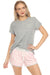 Woman wearing pajama set including a gray top and a pink short with "love" text graphic all over