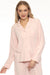 Woman wearing a pink cable knit button front pajama top with long sleeves and left chest pocket