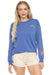 Woman wearing a blue pullover lounge top with rainbow, daisy, and palm tree embroidery