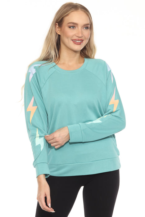 Woman wearing a sea green pullover French terry sweatshirt with gradient lightning bolt graphic on the sleeves