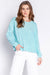 Woman wearing a light blue solid color pullover lounge t-shirt with crew neck and long sleeves