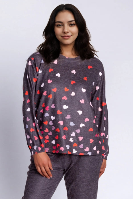 Woman wearing a dark gray lounge pullover top with hearts print all over