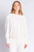 Woman wearing a white lounge pullover top made of velour with small metallic star embroidery