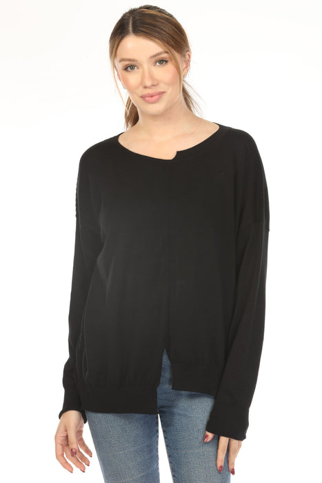 Woman wearing a black sweater top with cutout details and boat neck from Planet by Lauren G