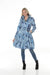 Woman wearing Samuel Dong indigo floral print bubble coat dress with statement collar and belt